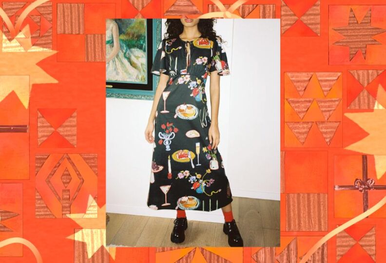 A photograph of a woman wearing a black dress that comes to mid calf, and is decorated with images of fine dining: A champagne flute, flowers, caviar, plates of food, and so one. The photo is set against a decorative orange-and-gold background, accented with stars, holiday gift boxes and strands of ribbon.