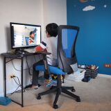 BARTLETT, ILLINOIS - MAY 01: Seven-year-old Hamza Haqqani, a 2nd grade student at Al-Huda Academy, uses a computer to participate in an E-learning class with his teacher and classmates while at his home on May 01, 2020 in Bartlett, Illinois. Al-Huda Academy, an Islam based private school that teaches pre-school through the 6th grade students, has had to adopt an E-learning program to finish the school year after all schools in the state were forced to cancel classes in an attempt to curtail the spread of the COVID-19 pandemic.  (Photo by Scott Olson/Getty Images)