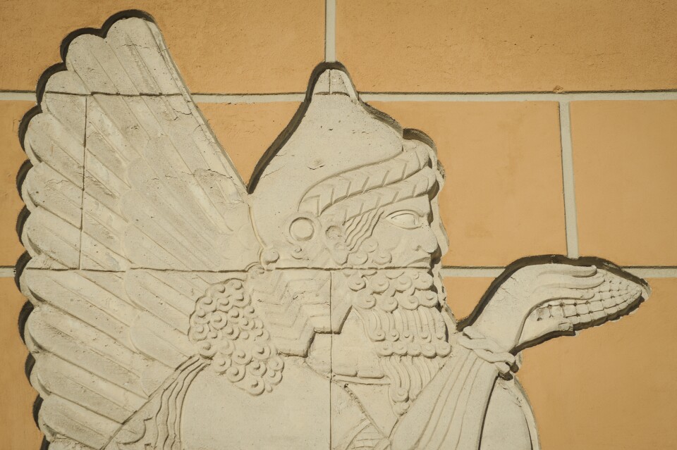 A concrete figure representing a genie, modeled on ancient carvings, decorates the Citadel Outlets in Commerce, California.  