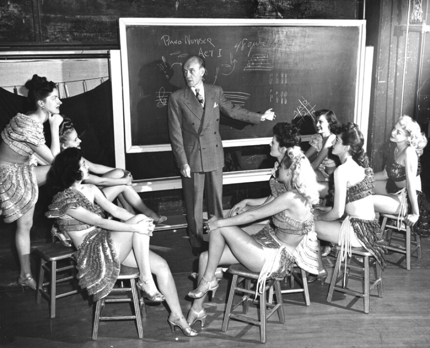 Earl Carroll planning a show with chorus girls in an undated photo.