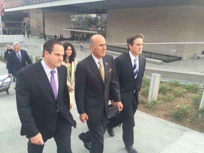 Former L.A. County Sheriff Lee Baca, center, leaves the federal courthouse on Wednesday, Dec. 14, 2016. His attorney, Nathan Hochman, is on his left.
