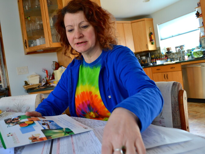 Kimberley Macgregor, a bookkeeper at a Burbank Ralphs, looks over which “healthy activities” she’ll choose to do to offset her health care costs. 
