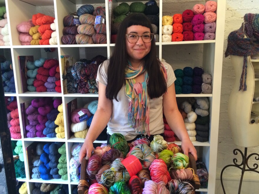 J.R. Jaffe holds a basket of yarns she hand-dyed to sell at Abuelita's