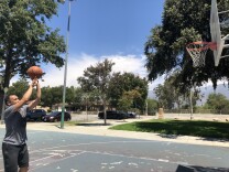 Raymond Pecson takes a shot at a park in East Pasadena, where the air quality is unhealthy for sensitive groups.
