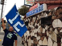 Cedric James Morris, founder of the Los Angeles Seahawks fan group, stands outside Backstage, in Culver City. The bar has become so overrun with Seahawks fans on Sundays that Morris has a list of overflow bars he hands out to fans when Backstage fills up.