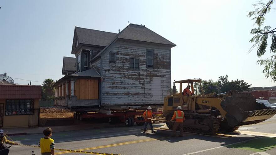 The 1895 Peabody Werden House being moved across the street on Thursday, June 30, 2016.