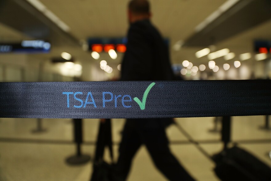MIAMI, FL - JUNE 02:  Travelers go through the TSA PreCheck security point at Miami International Airport on June 2, 2016 in Miami, Florida. As the busy summer travel season heats up the Transportation Security Administration is encouraging people to sign up for the TSA PreCheck program to save time going through the airports security lines. Those enrolled in the program can leave their shoes, light outerwear and belt on during the terminal screening process as well as keeping their laptop in the carry-on suitcase without having to remove them at the checkpoint.  (Photo by Joe Raedle/Getty Images)