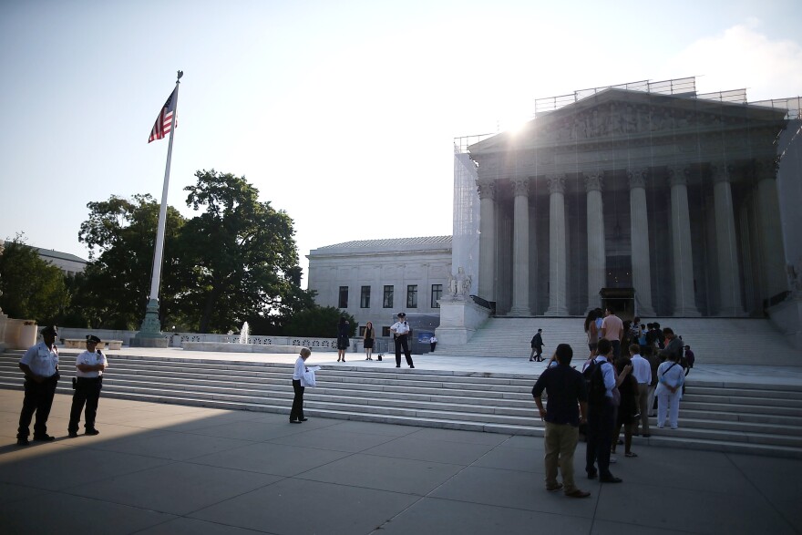 WASHINGTON, DC - JUNE 24:  People wait to enter the U.S. Supreme Court building June 24, 2013 in Washington DC. The high court may rule on several cases including Hollingsworth v. Perry which challenges California's Proposition 8, a ban on same sex marriage.  (Photo by Mark Wilson/Getty Images)