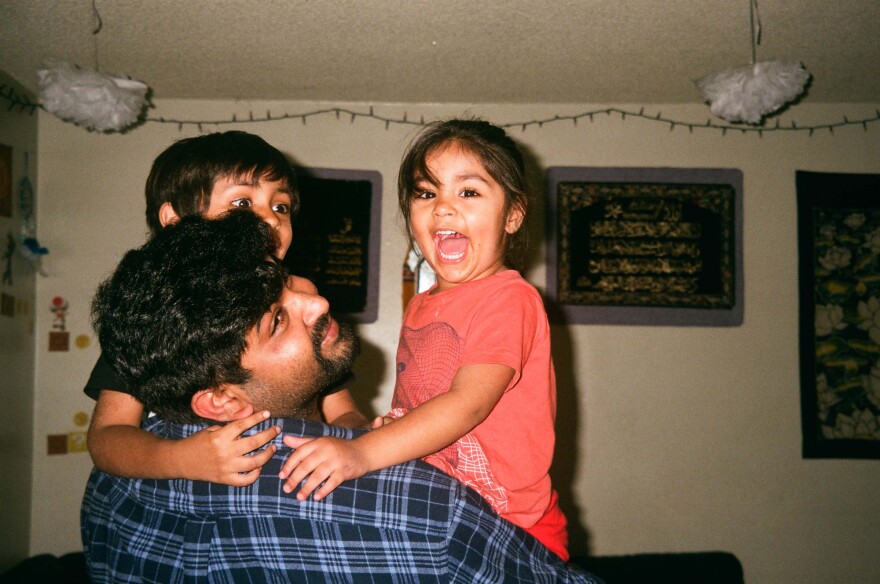 Mehboob plays with his two young children.
