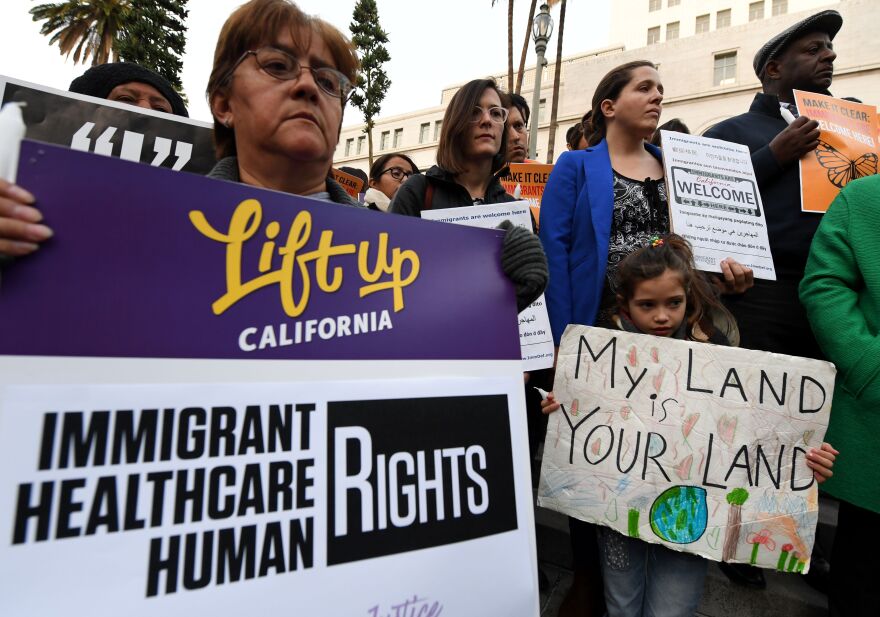Maya Casillas,7 (R), joins migrant rights groups during a vigil to protest against US President Donald Trump's new crackdown on "sanctuary cities", outside the City Hall in Los Angeles on January 25, 2017.
Some 300 such cities, counties or states -- from New York to Los Angeles -- exist throughout the United States, and many of them have vowed since Trump's election to protect the estimated 11 million undocumented migrants living in the country.
 / AFP / Mark RALSTON        (Photo credit should read MARK RALSTON/AFP/Getty Images)