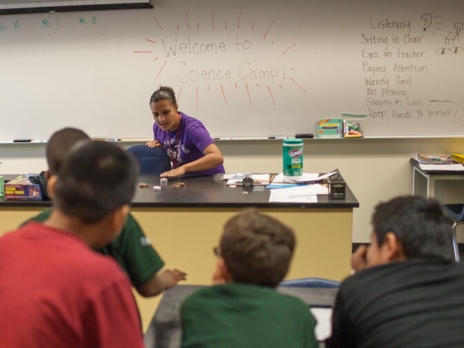 Sarah Aguinaga, a teacher at Belvedere Middle School, tells a class of young students about the science of reflections at a summer science camp.