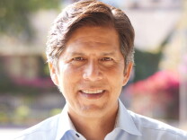 Headshot of a smiling man in a collared shirt. His hair is light brown with a dusting of gray over his ears.