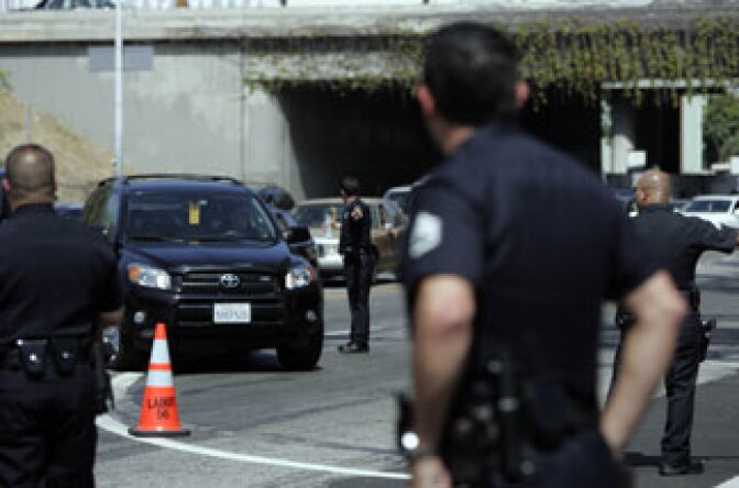 Police direct cars that are part of the motorcade outside the Michael Jackson public memorial service held at Staples Center on July 7, 2009.