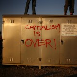 OAKLAND, CA - NOVEMBER 2:  Demonstrators with the Occupy movement stand on a utility box at the Port of Oakland November 2, 2011 in Oakland, California. Tens of thousands of protestors have marched to the Port of Oakland for a general strike organized by Occupy Oakland. Port operations shut down for the evening. (Photo by Eric Thayer/Getty Images)