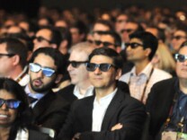 Moviegoers wear 3-D glasses to watch a 3-D film. 