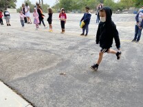 A first grader bounds toward a restroom on the campus of Brainard Avenue Elementary in Lake View Terrace. L.A. Unified School District campuses follow rules requiring six feet of distance between all staff and students at a time -- which means restroom capacity is limited.