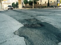 Two deep potholes at the corner of First Street and Glendale Boulevard near downtown L.A.