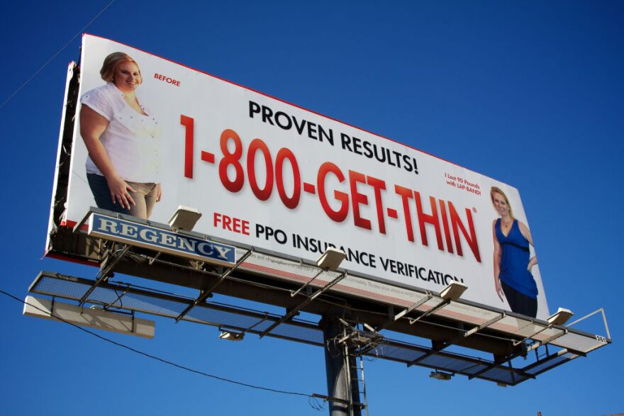 A billboard for the Lap Band over the 210 freeway.