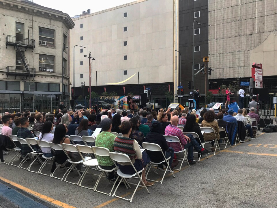 A crowd watched as the War of the Worlds performance began in a parking lot in downtown L.A. across the street from a decommissioned air raid siren. Set design by Calder Greenwood. Photo credit: Adriana Cargill