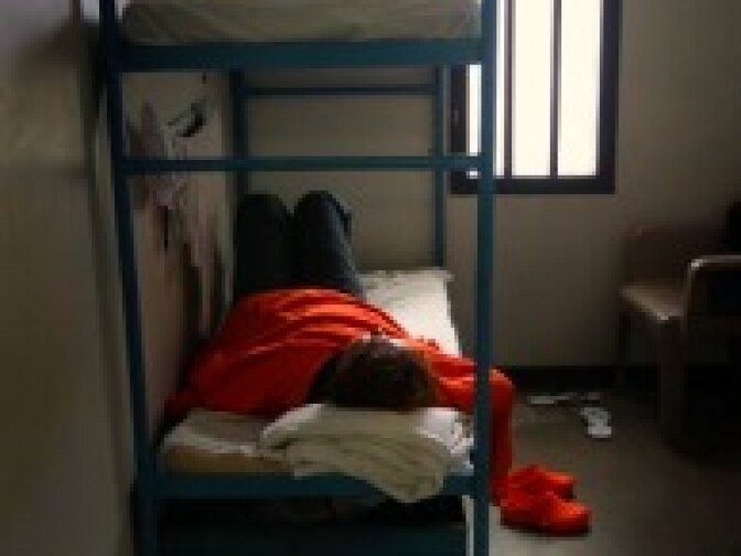 A female detainee lies in her housing cell in the women's wing of the Eloy Detention Facility for illegal immigrants on July 30, 2010 in Eloy, Arizona. The U.S. Immigration and Customs Enforcement holds almost 3,000 immigrants in Arizona.