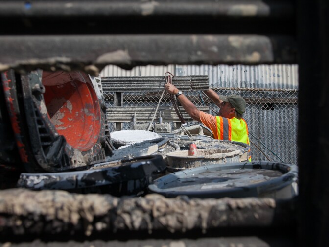Larry Bender, of Northeast Graffiti Busters, cleans up graffiti on the streets of Highland Park on Tuesday, Aug. 11, 2015. In addition to numerous colors and buckets of paint, Bender also brings along chemicals, water and sand blasters to use, depending on where the location is. 