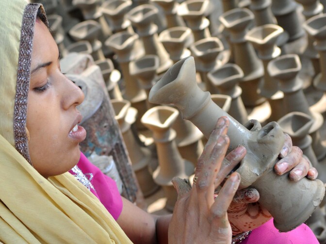 Indian craftswoman Bhawana prepares clay lamps ahead of the Hindu festival of Diwali in Amritsar on October 17, 2011.