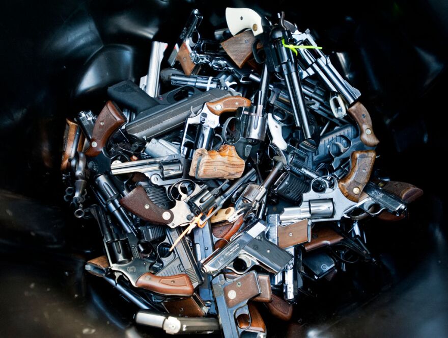 Handguns are thrown into trash bins for melting. Wednesday's event was the fifth-ever buyback. In the past the LAPD has recovered between 1,500 and 2,000 firearms each time.