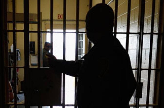 A California Department of Corrections officer at Chino State Prison waits for a prison door to be opened on December 10, 2010 in Chino, California.