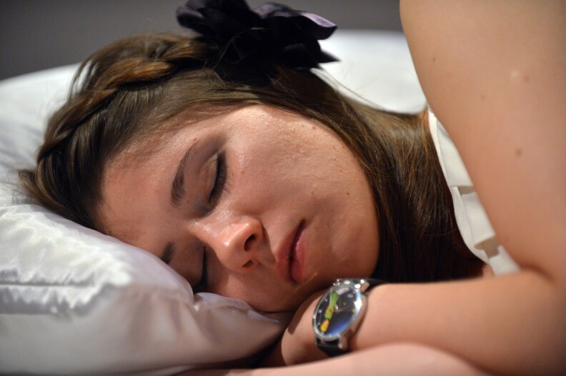 TO GO WITH AFP STORY BY ZOYA ZHMINKO A woman sleeps on September 5, 2012 during a performance at Ukraine's National Art Museum in Kiev. As a young woman in a white dress dozed on a dais, apparently undisturbed by cameras, Yana Krasnokutska walked over and kissed her lightly on the lips -- not provoking any reaction. A performance called 'Sleeping Beauty' at Ukraine's National Art Museum allows visitors to kiss a series of volunteer Sleeping Beauties, but only if they signed an undertaking to marry the women if she 'wakes up'. The wacky performance was created by Ukrainian-Canadian artist Taras Polataiko, who said he had been working on this project for the last two years. AFP PHOTO/ SERGEI SUPINSKY RESTRICTED TO EDITORIAL USE, MANDATORY MENTION OF THE ARTIST UPON PUBLICATION, TO ILLUSTRATE THE EVENT AS SPECIFIED IN THE CAPTION (Photo credit should read SERGEI SUPINSKY/AFP/GettyImages)