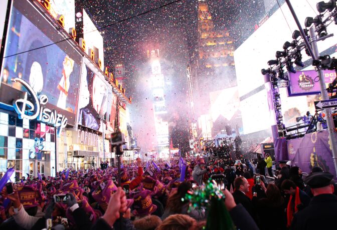 TOPSHOT - Revelers celebrate after the ball drop during New Year's Eve celebrations in Times Square on January 1, 2016 in New York. AFP PHOTO/ KENA BETANCUR / AFP / KENA BETANCUR        (Photo credit should read KENA BETANCUR/AFP/Getty Images)