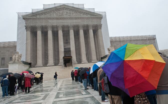 People queue to enter the Supreme Court in Washington in March 2013. The justices were hearing arguments on California's Proposition 8 ban on same-sex marriage and  on the federal Defense of Marriage Act. Today, The Supreme Court blocked further same-sex marriages in Utah while state officials appeal a decision allowing such unions.