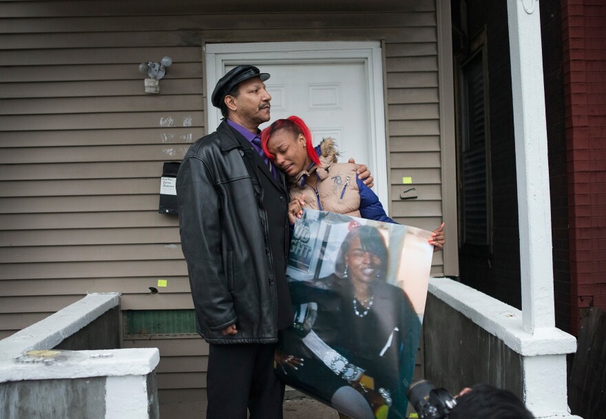 LaTonya Jones, the daughter of Bettie Jones, gets comfort from her father Garry Mullen during a vigil to honor Bettie, a 55-year-old mother of 5, on December 27, 2015 in Chicago, Illinois.
