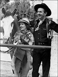 "Mr. and Mrs. Walt Disney, frequent vacationers at the B-Bar-H guest ranch in Palm Springs, are shown returning from a desert horseback ride on April 13, 1948.