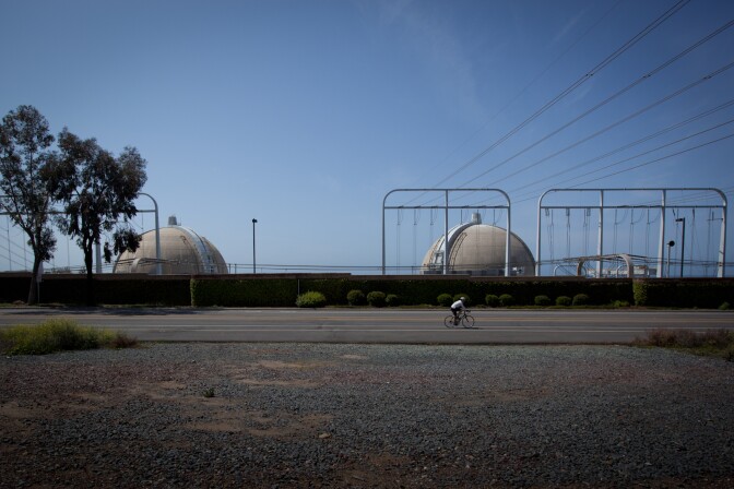 The San Onofre Nuclear Generating Station has been offline since a radioactive steam leak in January 2012. U.S. Sen. Barbara Boxer wants the Justice Department to investigate if California utility executives deceived federal regulators about an equipment swap at the San Onofre nuclear power plant that eventually led to the radiation leak. (Photo: A cyclist rides past the San Onofre Nuclear Power Plant on April 6, 2012.)