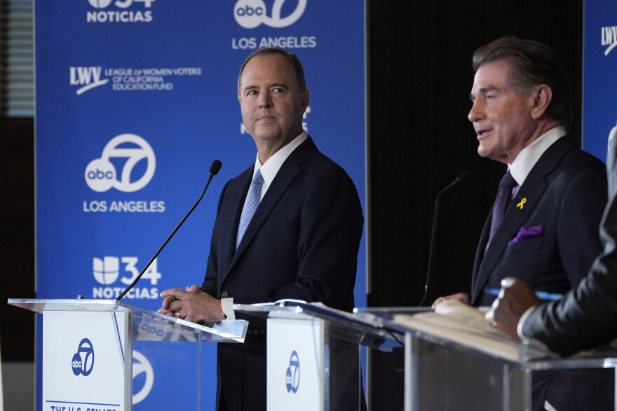 Two men with light-tone skin stand behind lecterns with mics and an ABC7 logo in front