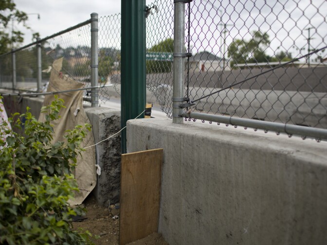People living in the Arroyo Seco riverbed use this small gap in a concrete barrier along a 110 Freeway on-ramp as an exit.