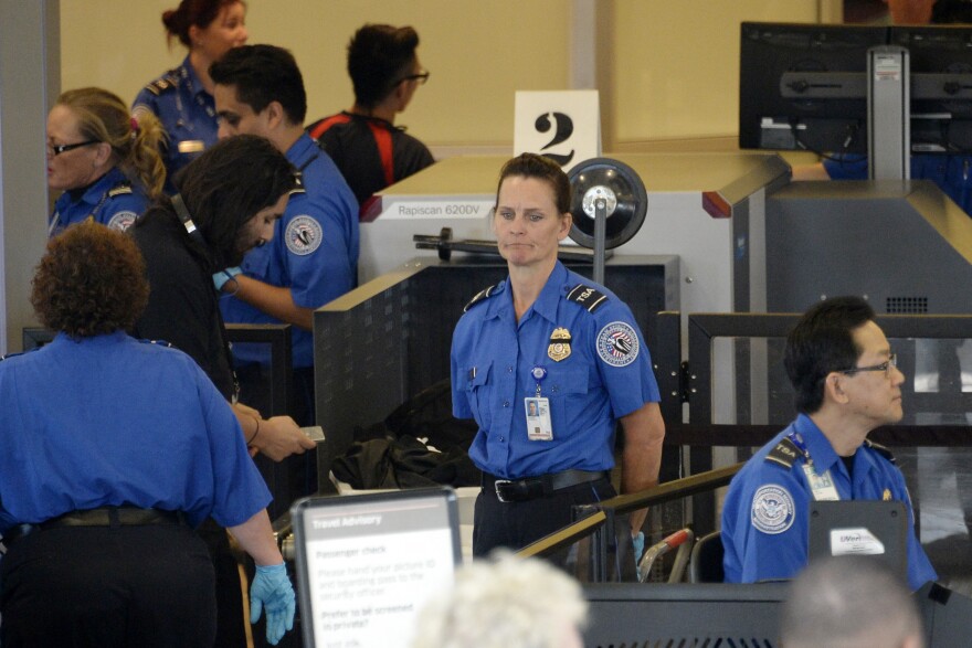 Travelers are screened by Transportation Security Administration agents after Terminal 3 was re-opened a day after a shooting at Los Angeles International Airport November 2, 2013 in Los Angeles, California. The airport is almost back to normal operations a day after a man pulled out an assault rifle and shot his way through security at Terminal 3, killing one Transportation Security Administration worker and wounding several others. Federal officials identified the alleged gunman as Paul Ciancia, 23. 