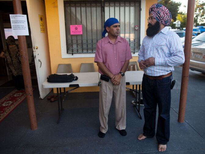 Jagjit Singh of Orange County (left) traveled to the Khalsa Care Foundation to be with other worshipers at the ceremony honoring the dead in a shooting this weekend in Wisconsin.