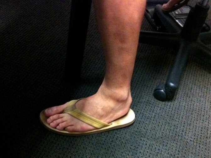 What Petros Papadakis wears on his battered feet when he does Petros and Money on KLAC