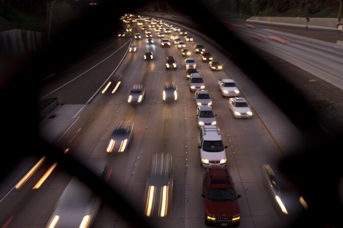 FILE - In this Nov. 22, 2011 file photo, cars travel on a freeway in San Diego. During the long 2014 holiday weekend, 46.3 million Americans are expected to go 50 miles or more from home, the highest number since 2007, according to travel agency and car lobbying group AAA. That would be a 4.2 percent increase over last year. (AP Photo/Gregory Bull, File)