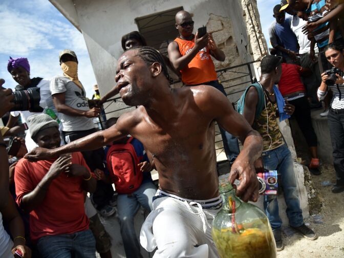 A devotee dances in a trance during a ceremony honoring the Haitian voodoo spirits of Baron Samdi and Gede on the Day of the Dead in the National Cemetery in Port-au-Prince, Haiti on November 1, 2016.