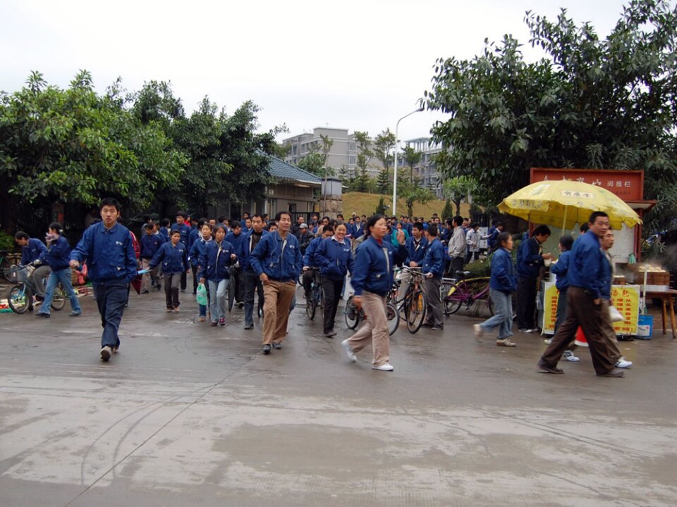 Workers pour out of the back gate of the Lacquer Craft furniture factory in Dalingshan, China, during a shift change. Some of the furniture jobs lost in Caldwell County, N.C., this decade ended up here at Lacquer Craft.