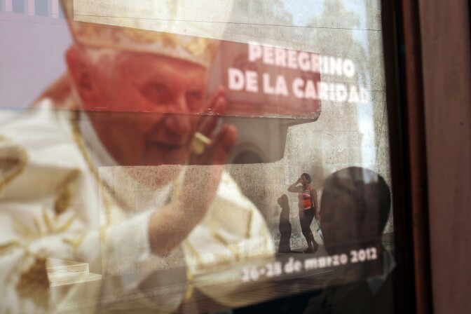A picture of Pope Benedict hangs in a window on March 22, 2012 in Santiago de Cuba, Cuba. The Pope will be moving onto Cuba after his Mexico visit.