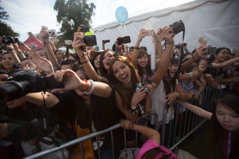 Tina Hing The Doan screams at the arrival of Exo to a photo session outside the autograph tent at KCON on Saturday.
