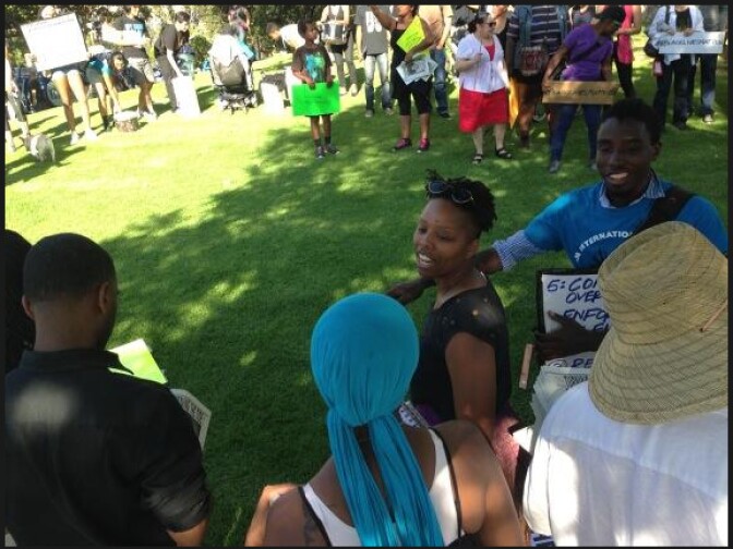A crowd gets organized before the march down Wilshire Boulevard in Beverly Hills during the fifth day of protests related to the killing of Trayvon Martin and the subsequent acquittal of George Zimmerman of criminal charges in the slaying of the teenager.
