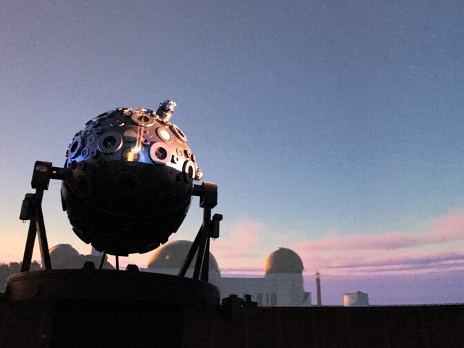 The Zeiss star projector at Griffith Observatory stands inside the planetarium. An image of the Observatory at sunset is projected in the dome using all new digital projectors.