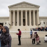 WASHINGTON, DC - OCTOBER 11: People take photographs outside the U.S. Supreme Court, October 11, 2017 in Washington, DC. On Tuesday, the U.S. Supreme Court dismissed one of two cases challenging the Trump administration's effort to restrict travel from mostly Muslim countries. The court dismissed the case because the travel ban has since been replaced with a new version of the administration's controversial travel restriction. (Photo by Drew Angerer/Getty Images)