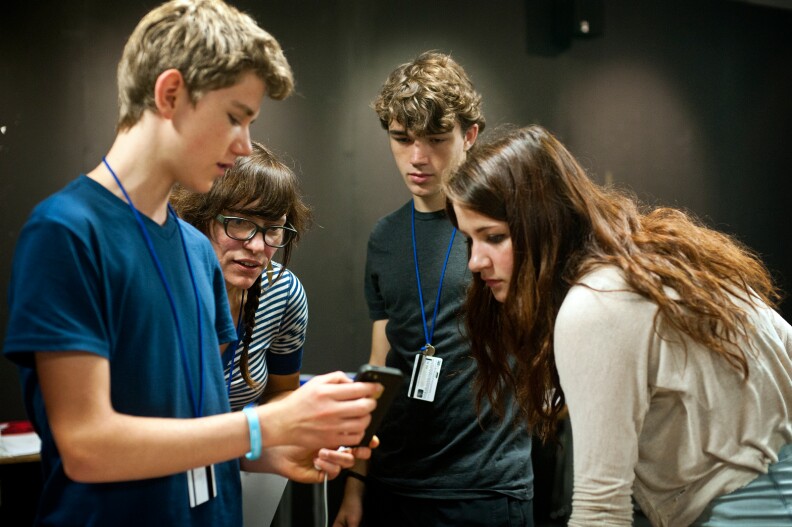 Teacher Lori Damiano and animation students Kannon Rickell and Kira Buro look at their classmate Devan Muchnij's progress in his project during the California State Summer School for the Arts program at CalArts.