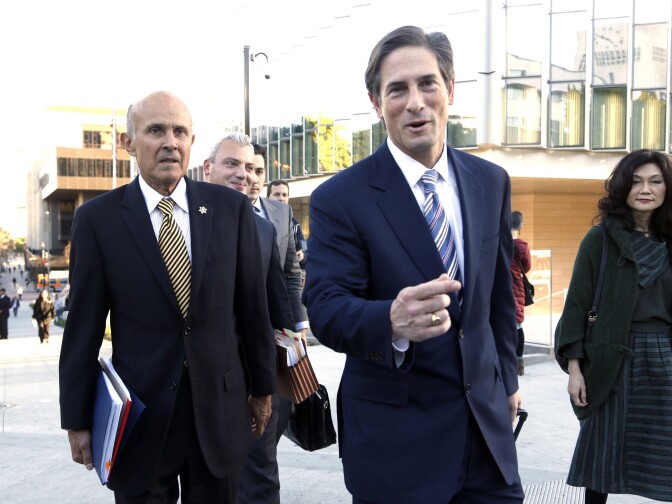 Former Los Angeles County Sheriff Lee Baca, left, his attorney Nathan Hochman, center, and Baca's wife Carol leave federal court in Los Angeles, Monday, Dec. 19, 2016, after the prosecution and defense presented their closing arguments and the case went to the jury.