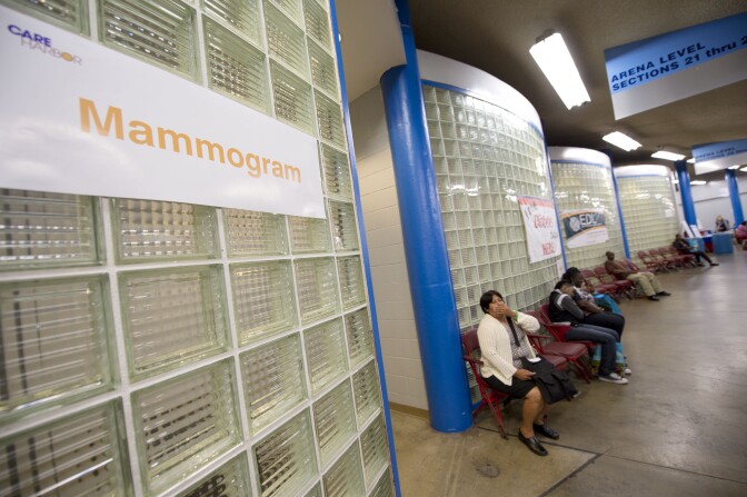 A woman waits outside the mammogram and women's health services area on the first day of the fourth annual free health clinic at the Los Angeles Sports Arena in downtown Los Angeles September 27, 2012. The free clinic, organized by nonprofit Care Harbor, aims to provide medical, vision and dental care at no charge for thousands of needy residents over a four day period. Health care is one of the top issues in the upcoming presidential election. Some 49.9 million Americans, or 16.3 percent of the total US population, are uninsured, according to CNN. AFP PHOTO / Robyn Beck (Photo credit should read ROBYN BECK/AFP/GettyImages)